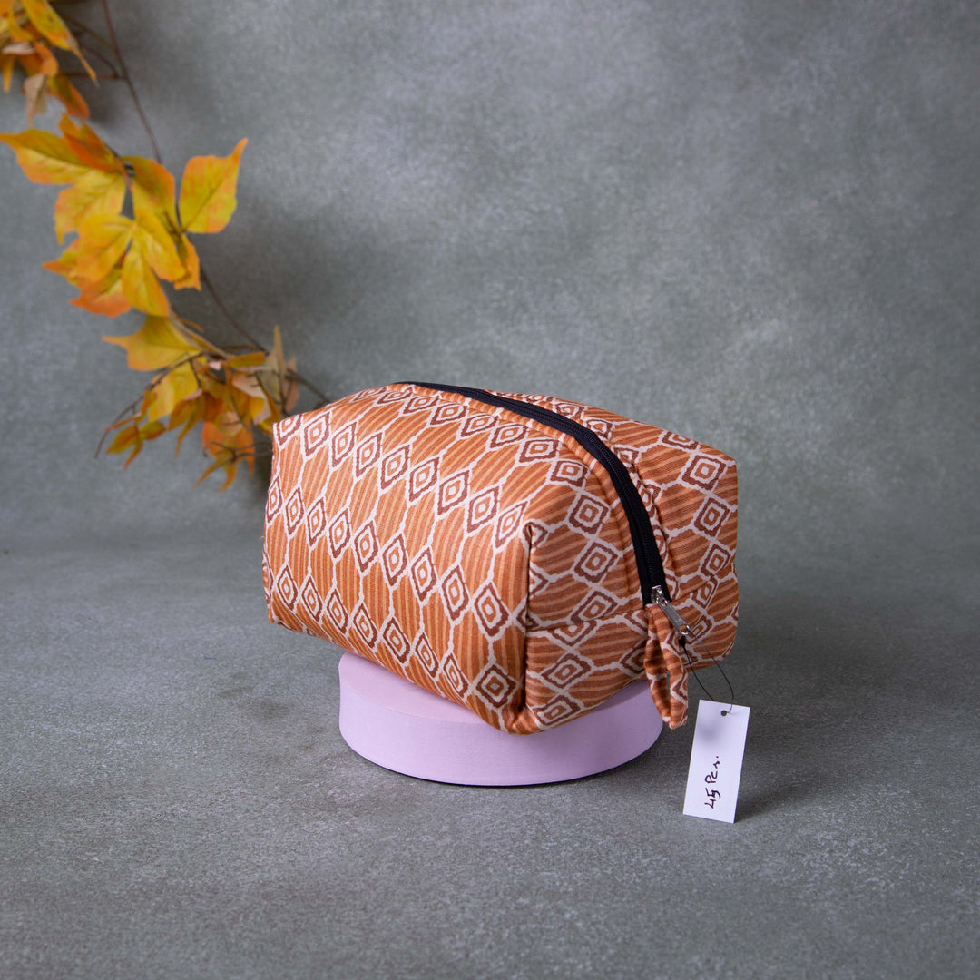 Vanity Pouch Orange with Sandal and Brown Symmetrical Design.